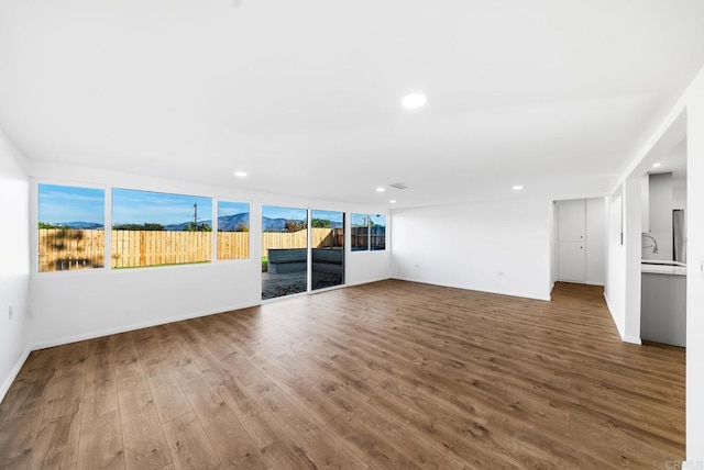 unfurnished living room featuring hardwood / wood-style flooring