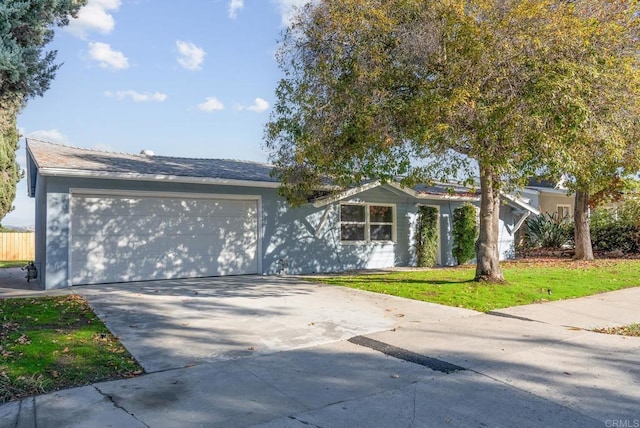 ranch-style home with a garage and a front yard