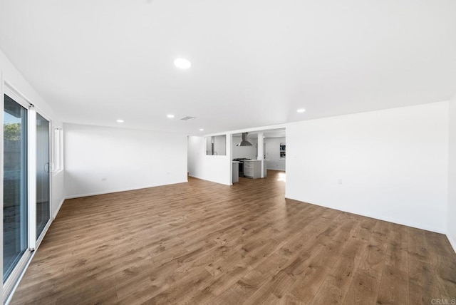 unfurnished living room featuring dark hardwood / wood-style floors