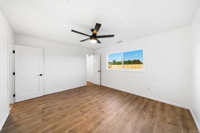 empty room with hardwood / wood-style flooring and ceiling fan