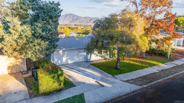 view of front facade featuring a garage and a mountain view