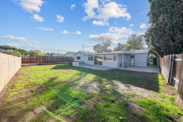 back of property with a patio area and a lawn