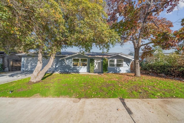 view of front of property featuring a garage and a front lawn