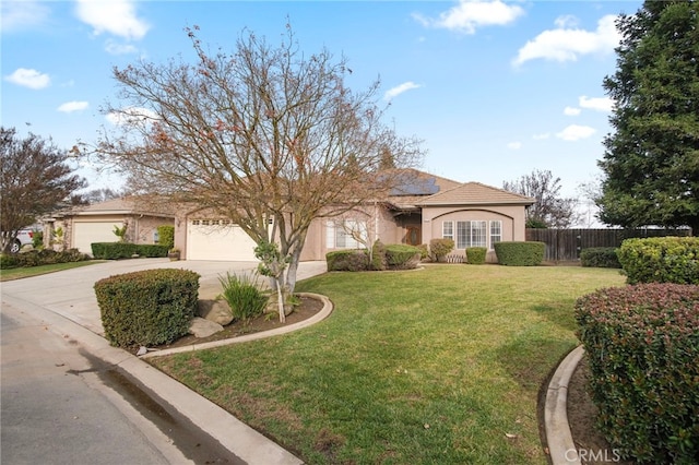 mediterranean / spanish home with a garage and a front lawn