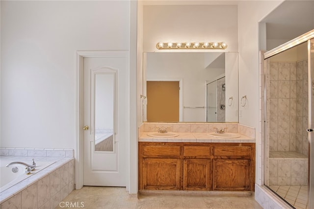 bathroom with vanity, independent shower and bath, and tile patterned flooring