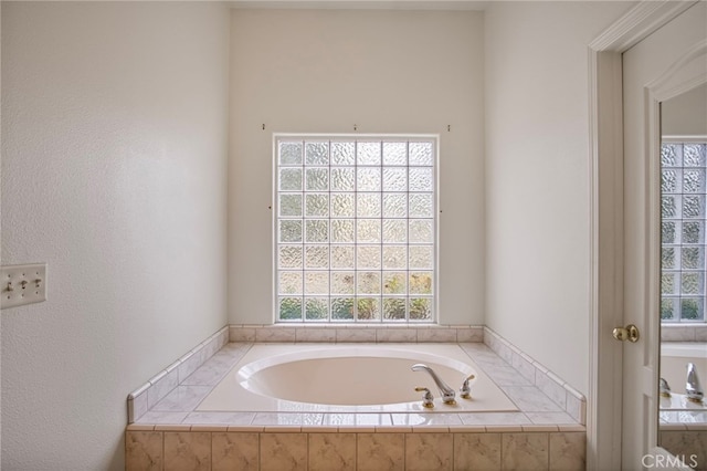 bathroom featuring a relaxing tiled tub