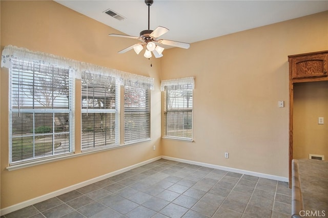 tiled empty room with ceiling fan