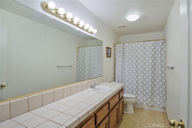 bathroom with vanity, toilet, and tile patterned flooring