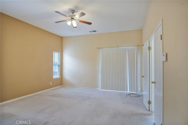 unfurnished room featuring ceiling fan and light carpet