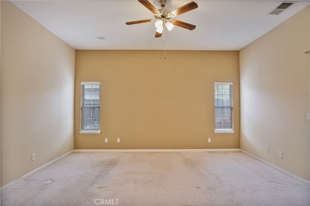 unfurnished room featuring ceiling fan and light colored carpet