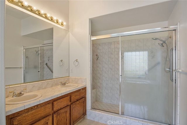 bathroom featuring walk in shower and vanity