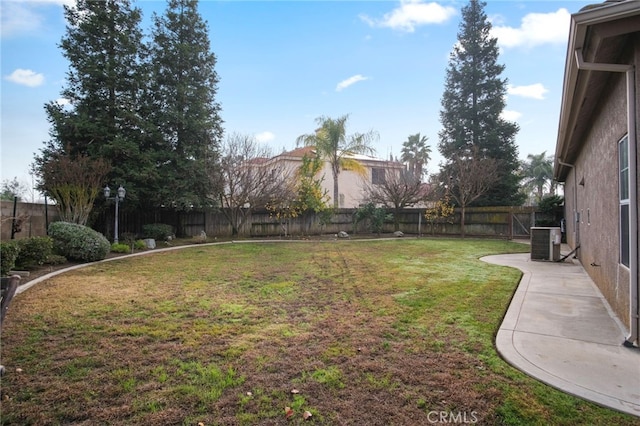 view of yard featuring central AC unit and a patio