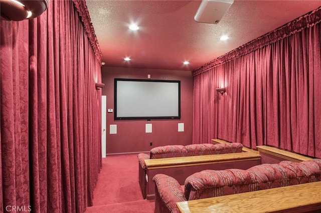 carpeted cinema room with a textured ceiling