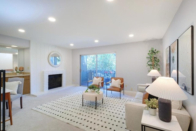 carpeted living room with a brick fireplace