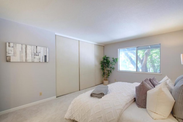 carpeted bedroom featuring a closet