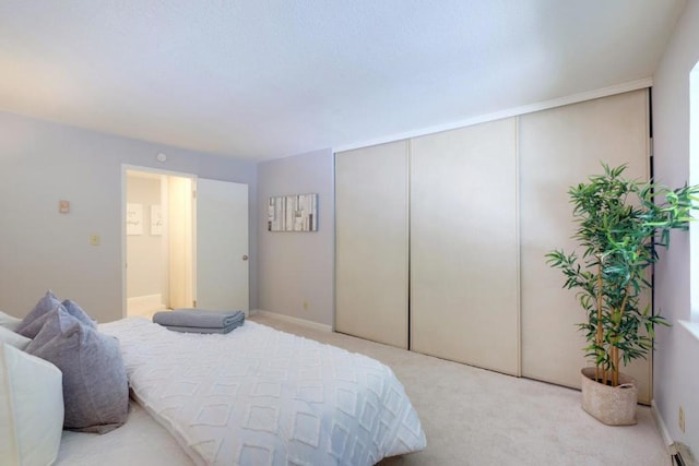 bedroom featuring light colored carpet and a closet