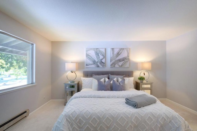 bedroom featuring light colored carpet and baseboard heating