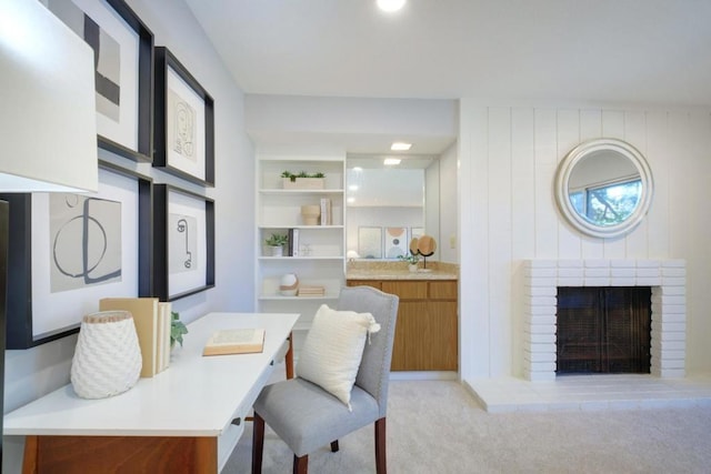 carpeted office with a brick fireplace