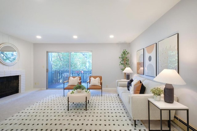 living room with a brick fireplace, a baseboard radiator, and light colored carpet