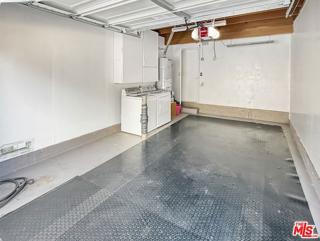 garage with strapped water heater, a garage door opener, and washing machine and dryer