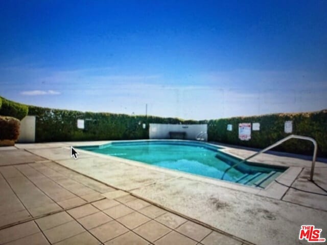 view of swimming pool featuring a patio area