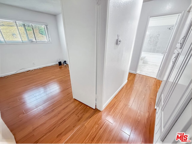 hall with light hardwood / wood-style flooring