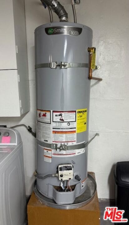 utility room featuring washer / clothes dryer and water heater