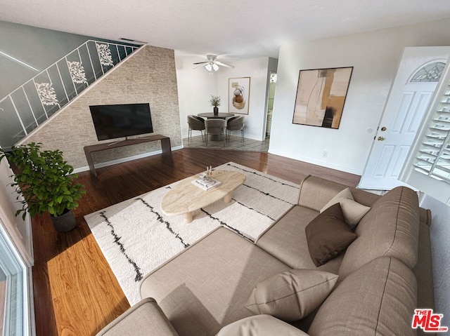 living room with dark hardwood / wood-style floors and ceiling fan