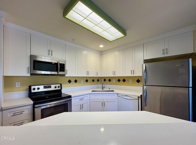 2713 Antonio Dr Unit 104, Camarillo, CA 93010 - kitchen featuring appliances with stainless steel finishes, light countertops, white cabinets, and recessed lighting