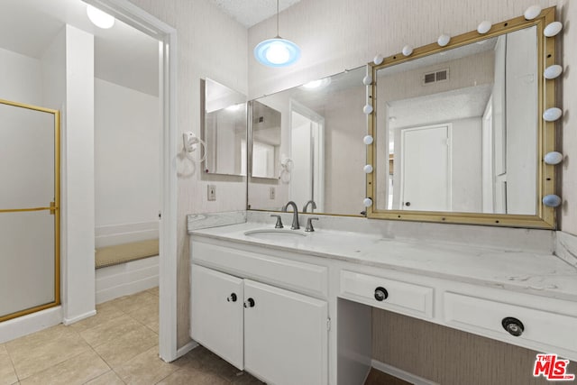 bathroom with vanity, tile patterned flooring, and a shower with door