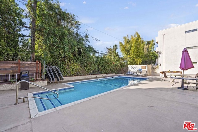 view of swimming pool with a patio