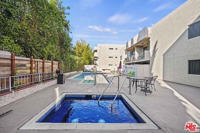 view of swimming pool with a patio area