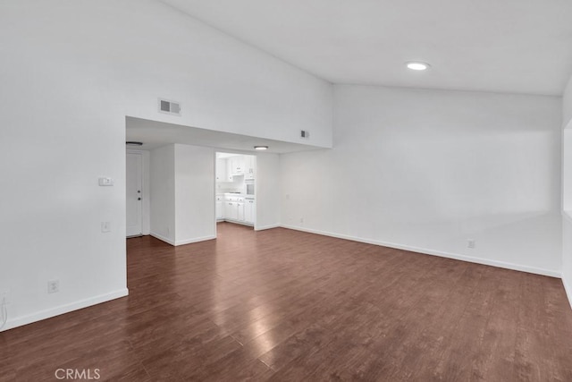 unfurnished living room with dark hardwood / wood-style floors and high vaulted ceiling