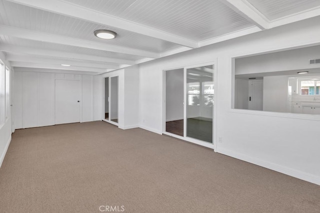 empty room with carpet flooring and beam ceiling