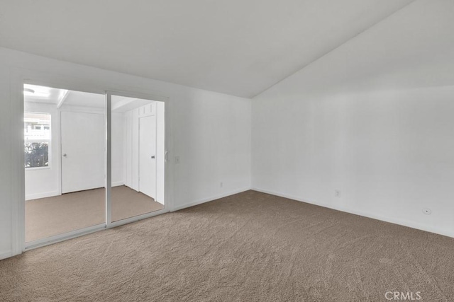 interior space featuring carpet and lofted ceiling