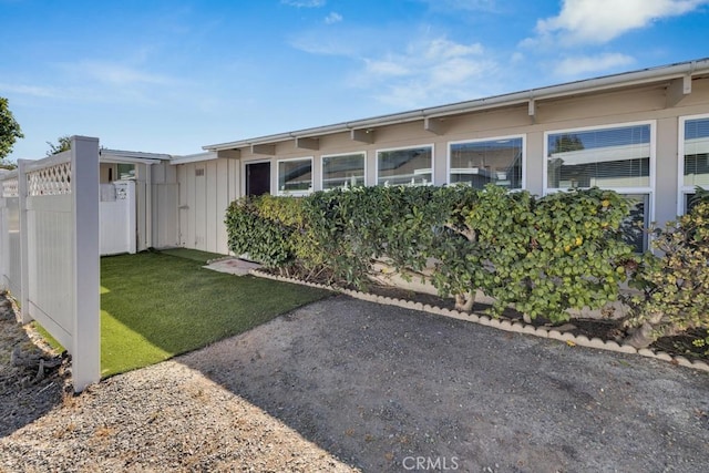 view of side of home with a yard