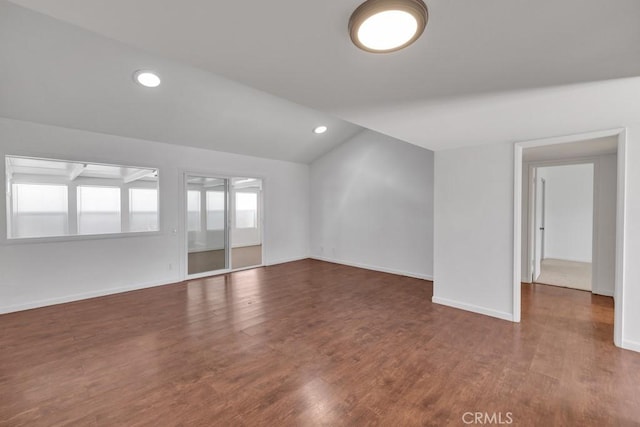 empty room with vaulted ceiling and dark wood-type flooring