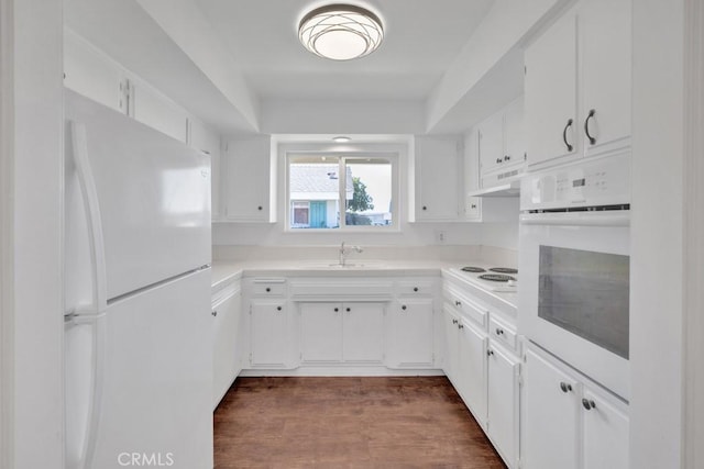 kitchen featuring white cabinetry, white appliances, dark wood-type flooring, and sink