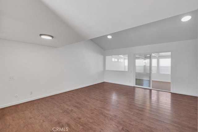 interior space with vaulted ceiling and dark hardwood / wood-style floors