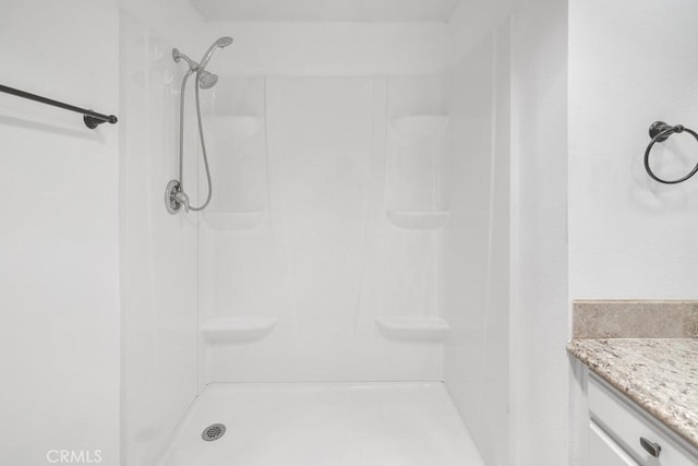 bathroom with vanity and a shower