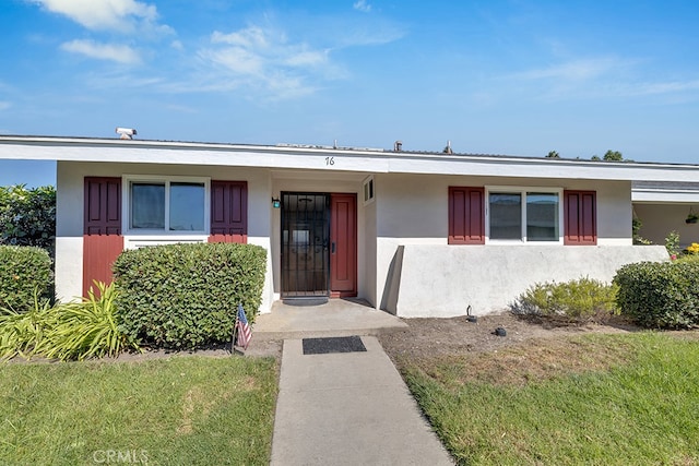 ranch-style house with a front lawn