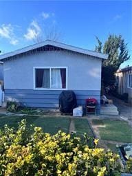 view of side of home with a lawn