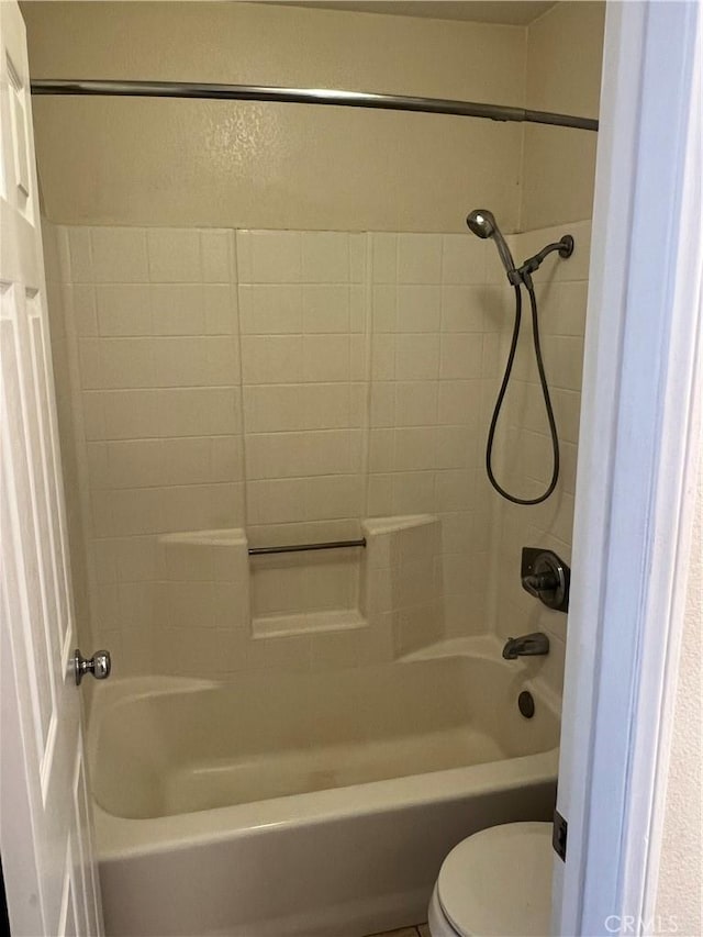 bathroom featuring toilet and shower / bathing tub combination