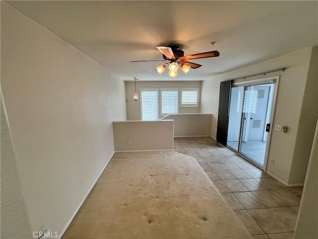 spare room featuring light tile patterned floors and ceiling fan