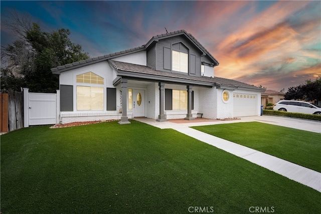 view of front facade with a garage and a lawn