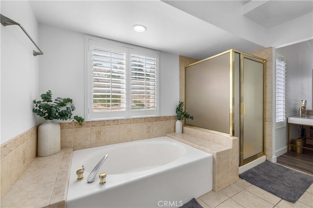 bathroom featuring shower with separate bathtub and tile patterned flooring