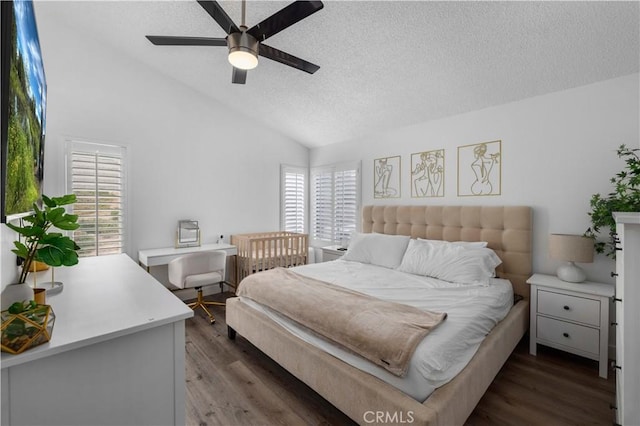 bedroom featuring vaulted ceiling, dark wood-type flooring, ceiling fan, and a textured ceiling