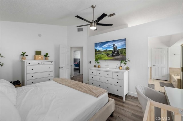 bedroom with vaulted ceiling, ceiling fan, and hardwood / wood-style floors