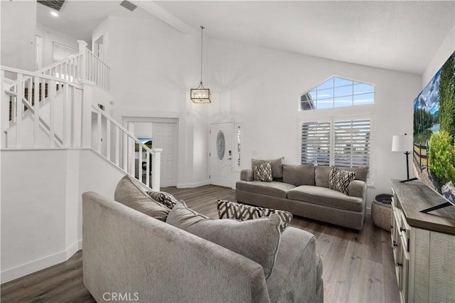 living room featuring dark wood-type flooring and high vaulted ceiling