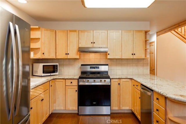 kitchen featuring appliances with stainless steel finishes, dark hardwood / wood-style floors, light brown cabinets, and backsplash